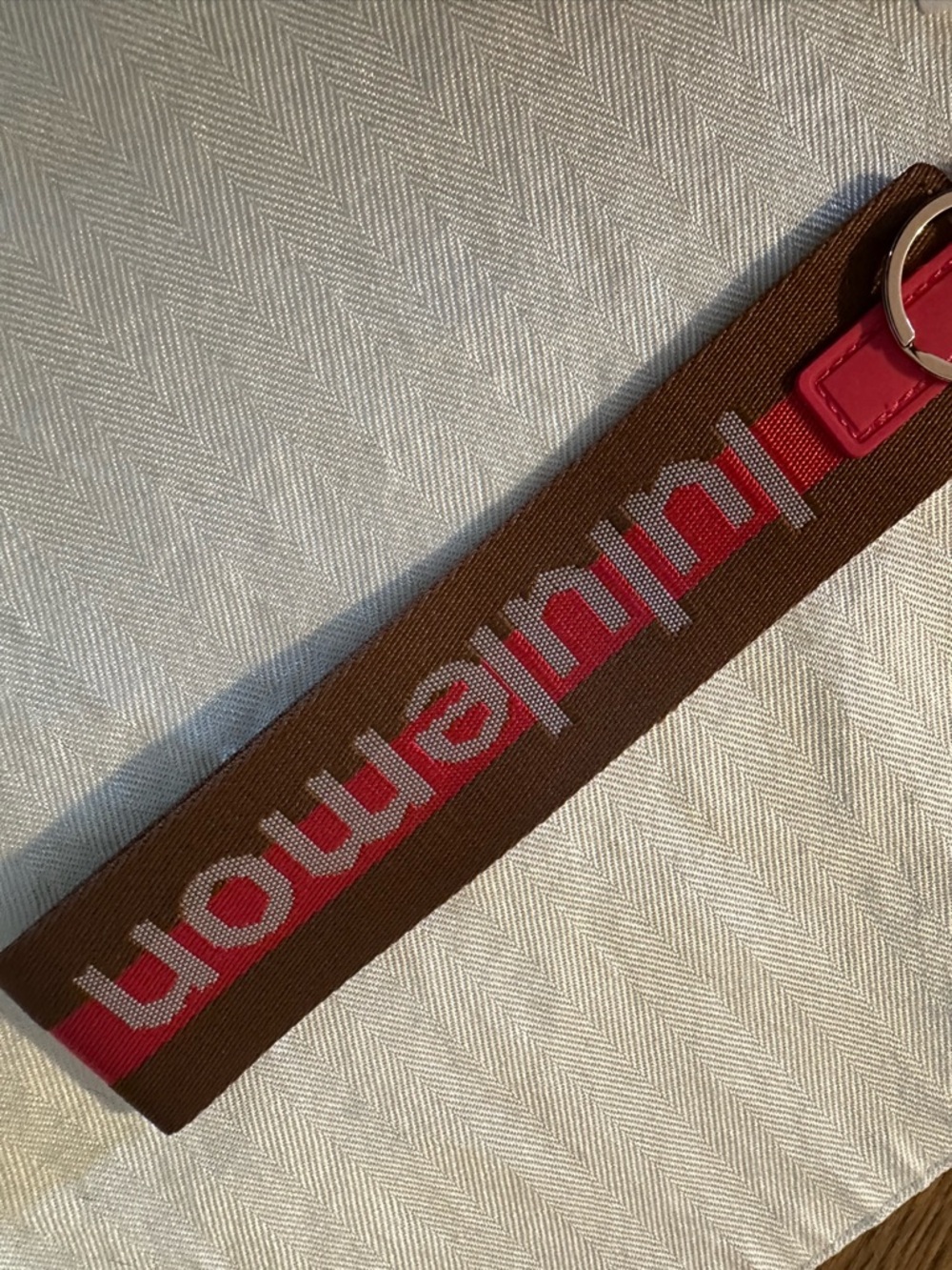 lululemon Brown Strap with Pink Accent and Gold Hardware never lost keychain